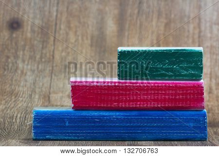 Green, red and blue wooden painted blocks stacked for copy space