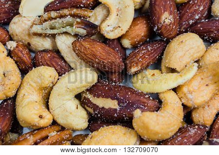 Nut background with peanuts, cashews, walnuts and almonds