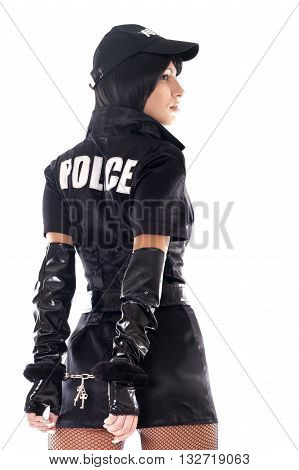 Portrait of beautiful sexy policewoman with handcuffs in a black uniform isolated on white.