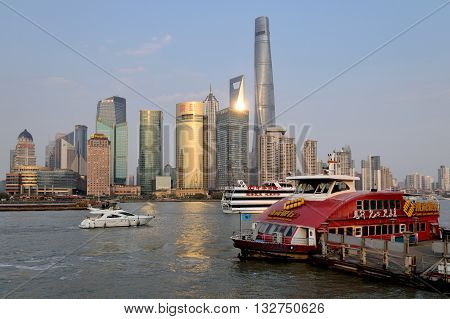 SHANGHAI CHINA - MARCH 25: Pudong district view from The Bund waterfront area on March 25 2016 in Shanghai China. Pudong is a district of Shanghai located east of the Huangpu River.