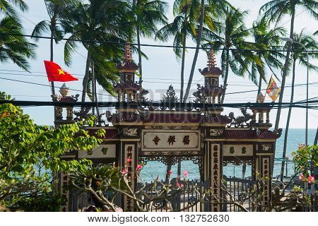 Beautiful Temple. Gate And The Flag Of Vietnam.mui Ne, Vietnam.