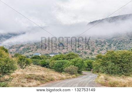 MOUNTAIN ZEBRA NATIONAL PARK SOUTH AFRICA - FEBRUARY 19 2016: The Doornhoek Guest Cottage in the Mountain Zebra National Park near Cradock with the lower part of the Kranskop Loop road in the front