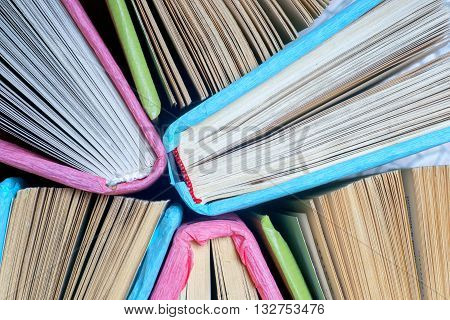 Old and used colorful hardback book or text books seen from above. Back to school.