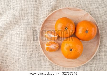 Group Of Mandarin Oranges, Tangerines Fruit On Burlap Sack Background