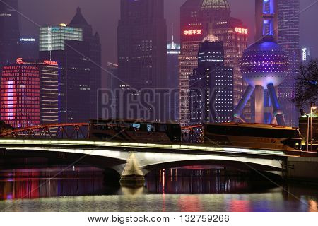 SHANGHAI CHINA - MARCH 19: Pudong district night view from Suzhou Creek on March 19 2016 in Shanghai China. Pudong is a district of Shanghai located east of the Huangpu River.