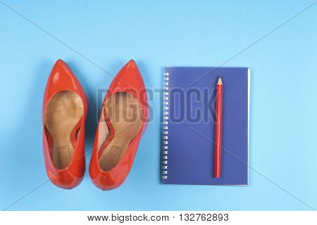 Women clothing set set of cool stuff and accessories on light blue background. Top view.