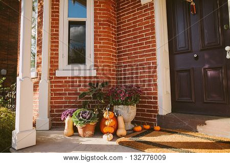 Pumpkin decoration for Thanksgiven near door outside a house
