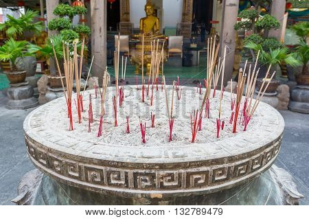 BANGKOK THAILAND -7 MAY 2016 : Incense burner and Golden buddha statue in Wat Kalayanamitr Bangkok, Thailand