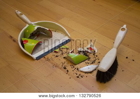 Brooming broken flower pot with small brush