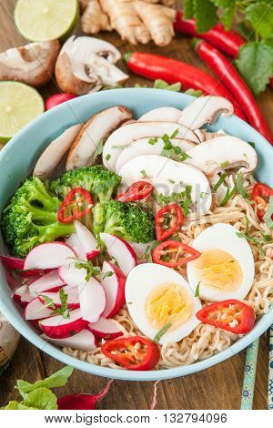 Asian ramen noodle soup with fresh veggies and hardboiled egg