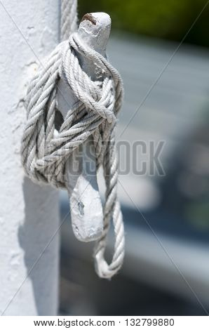 Halyard tied off to cleat on flagpole