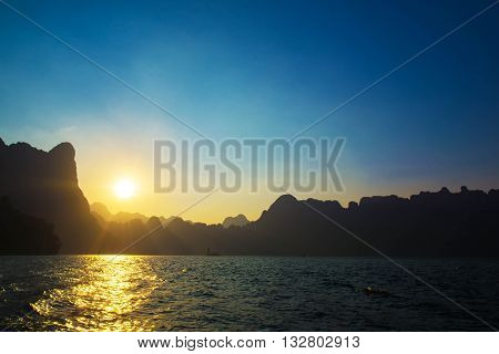 Sunset behind mountain and blue sky at Khaosok Lake Thailand