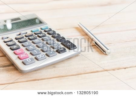 Blank white notebook with pen on wood desk. shallow depth of field