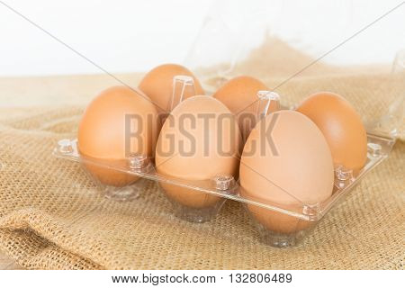 Eggs with heap on wood table background