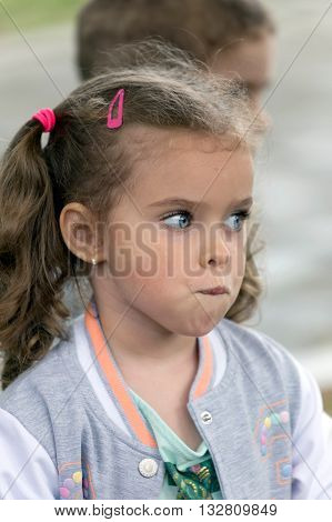 TIMISOARA ROMANIA - JUNE 1 2016: Portrait and expression of one little girl that expected place at one workshop with face painting for children. International children day.