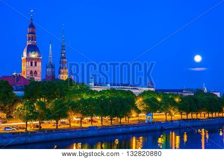 Old Town Of Riga With Reflection In Daugava River At Night. Riga, Latvia