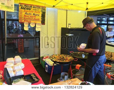 AUCKLANDJUNE 4: Cook prepare paella is a Valencian rice dish at the La Cigale French Market in Auckland New Zealand on June 4 2016.