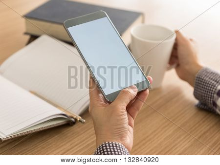 women using mobile phone in cafe. sofe focus. blank screen for your advertising.