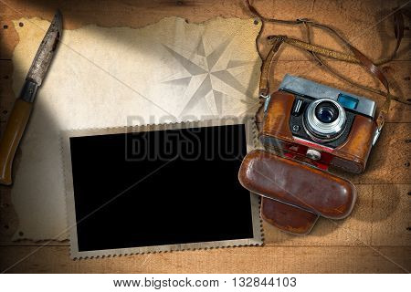 Old and vintage camera with leather case empty parchment photo frame and a pen knife. Template for adventurous travels