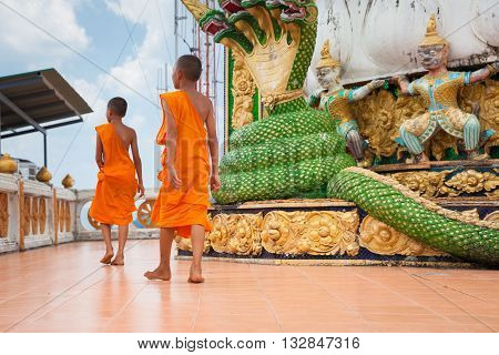 KRABI THAILAND - APRIL 10: Novice monks are observing hilltop of the Tiger Cave Mountain Temple on April 10 2016 in Krabi Thailand.