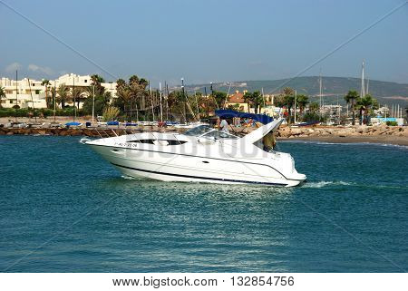 PUERTO SOTOGRANDE, SPAIN - JULY 18, 2008 - Motor boat travelling alongside the beach Puerto Sotogrande Cadiz Province Andalucia Spain Western Europe, July 18, 2008.
