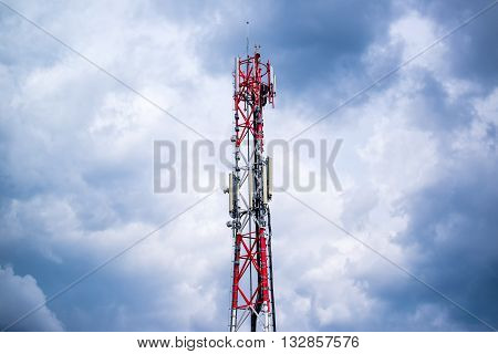 Mobile phone network GSM communication repeater antenna against cloudy sky