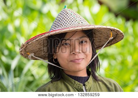NGAPALI MYANMAR - JANUARY 23 2016: Portrait burmese girl a straw hat in local market. Myanmar Burma