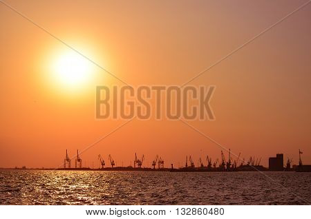 Silhouette of cranes at the harbor at sunset