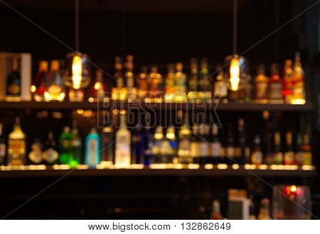 blur alcohol drink bottle at pub in dark night background