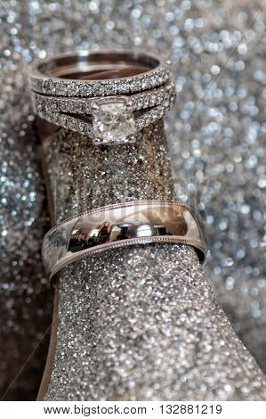 Wedding rings sparkling against the wedding shoe heel.