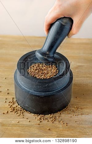 Stone mortar and pestle on a wooden background