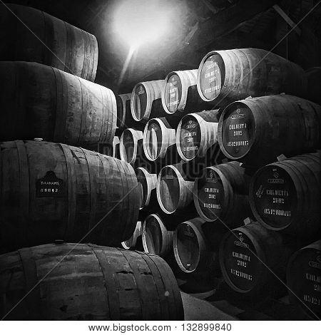 PORTO PORTUGAL - MAY 2 2015: Barrels or pipes of vintage port wine are stacked up in a cellar at Graham's storage facility in the city of Porto in Portugal.