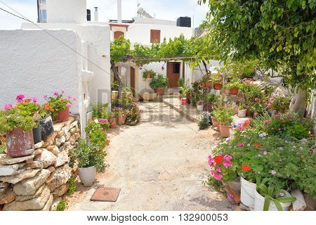 The narrow street with old houses in the historic part of Hersonissos Crete Greece.