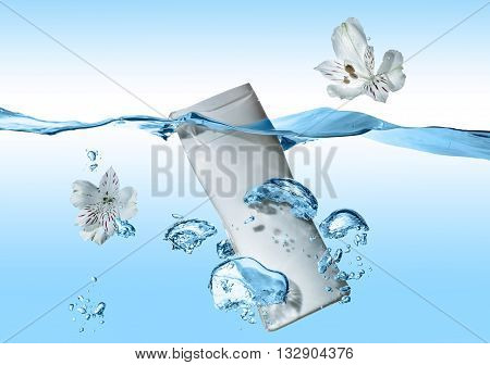The bottle of cosmetic milk, cosmetic cream, cosmetic water in the blue water wave with splash and  big air bubbles  and with two white flowers near the bottle