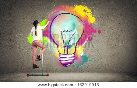 Young woman in casual drawing creativite idea concept on wall