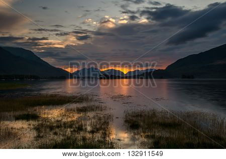 Loch Leven in Glencoe with colorful sunset in background Highland Scotland