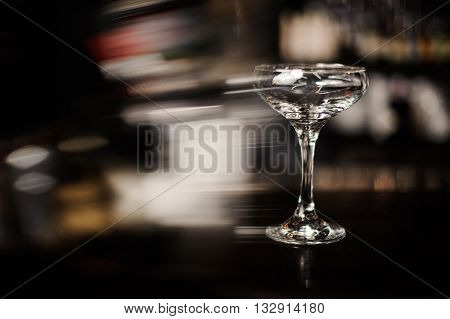 ampty champagne cocktail glass on bar freezelight