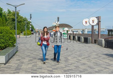 DNEPR UKRAINE - MAY 21 2016:Young couple walking on the Dnepr river embankment at May 21 2016 in Dnepr Ukraine