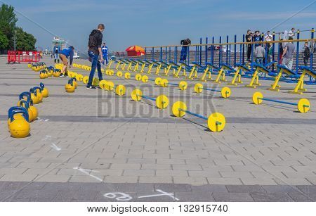DNEPR UKRAINE - MAY 21 2016:Young people working on the Dnepr river embankment preparing for workout festival at May 21 2016 in Dnepr Ukraine