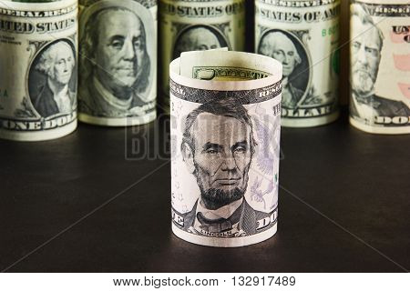 The President notes with five dollars on a background of presidents from other denominations