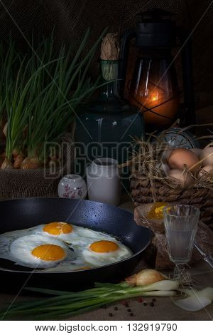 Eggs fried in a pan  and green onion