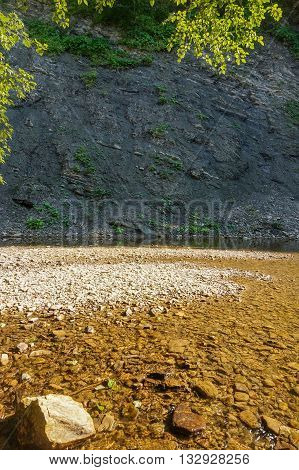 Sandbank on a mountain river with rocky shores