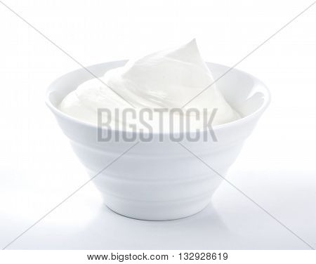 Bowl of sour cream isolated on white background