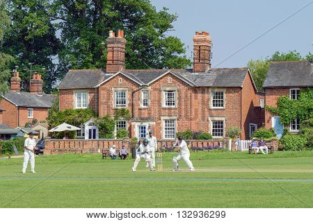 Hartley Wintney, HAMPSHIRE/UK- JUNE 5TH 2016 :Village cricket being played at Hartley Wintney in Hampshireon June 5th 2016. Unidentified people.