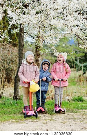 Treee Children On The Scooters