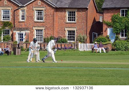 Hartley Wintney, HAMPSHIRE/UK- JUNE 5TH 2016 :Village cricket being played at Hartley Wintney in Hampshireon June 5th 2016. Unidentified people.