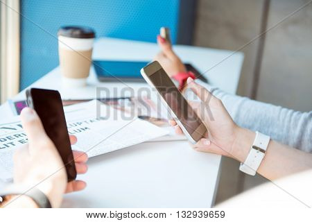Digital modern world.  Concentrated modern young people using their cell phones and being fully involved in it