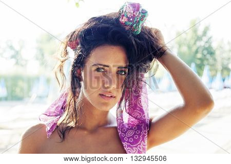 Portrait Of Pretty Woman Wearing Colored Foulard In The Hair Near The Pool