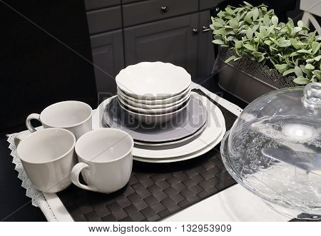 Kitchen Utensil Table Set of Ceramic Dishes Bowls Plates and and Coffee Cups Preparing for Serve Hot and Cold Food.