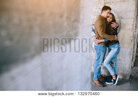 handsome guy and beautiful girl posing in a bystreet